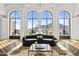 Living room with arched windows showcasing mountain views, a dark sofa, and a coffee table at 7046 N 59Th Pl, Paradise Valley, AZ 85253