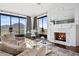 Living room with fireplace, mountain views, and stylish furniture at 7046 N 59Th Pl, Paradise Valley, AZ 85253