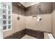 Large walk-in shower with tile surround and glass block feature at 16358 W Whitton Ave, Goodyear, AZ 85395