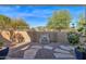 Landscaped backyard with a stone fountain and sitting area at 21254 E Cherrywood Dr, Queen Creek, AZ 85142