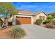 Two-car garage with tan door and landscaping at 21254 E Cherrywood Dr, Queen Creek, AZ 85142