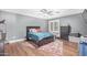 Bedroom with wood floors, ceiling fan and plenty of light at 5702 W Windrose Dr, Glendale, AZ 85304