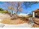 Large backyard with patio, firepit, and mature trees at 5702 W Windrose Dr, Glendale, AZ 85304