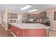 Kitchen with an island, stainless steel appliances, and dark wood cabinets at 5702 W Windrose Dr, Glendale, AZ 85304