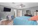 Spacious bedroom with a large TV, ceiling fan and walk-in closet at 5702 W Windrose Dr, Glendale, AZ 85304