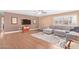 Spacious living room featuring a sectional sofa, wood floors, and large windows at 5702 W Windrose Dr, Glendale, AZ 85304