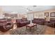 Open living room with leather sofas, and access to kitchen and backyard at 5702 W Windrose Dr, Glendale, AZ 85304
