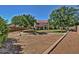 Large backyard with grassy area and mature trees at 5702 W Windrose Dr, Glendale, AZ 85304