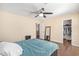 Bedroom with wood floors, ceiling fan and walk-in closet at 5702 W Windrose Dr, Glendale, AZ 85304