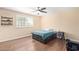 Well-lit bedroom with wood floors and a ceiling fan at 5702 W Windrose Dr, Glendale, AZ 85304