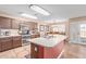 Open kitchen with island, stainless steel appliances, and view to dining area at 5702 W Windrose Dr, Glendale, AZ 85304