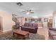 Spacious living room with leather furniture and a view of the kitchen at 5702 W Windrose Dr, Glendale, AZ 85304