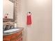 Small bathroom with dark wood vanity, tile backsplash, and modern fixtures at 5702 W Windrose Dr, Glendale, AZ 85304