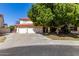 Beautiful two-story home with a three-car garage and lush landscaping at 5702 W Windrose Dr, Glendale, AZ 85304