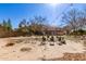 Landscaped backyard featuring a firepit and seating area at 5702 W Windrose Dr, Glendale, AZ 85304