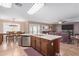 Open kitchen with large island, stainless steel appliances, and views to living room and backyard at 5702 W Windrose Dr, Glendale, AZ 85304