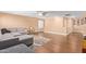 Open living area with gray sectional sofa and wood-look flooring at 5702 W Windrose Dr, Glendale, AZ 85304