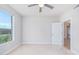 Bright bedroom with large window, ceiling fan, and neutral wall colors at 4803 N Woodmere Fairway -- # 2006, Scottsdale, AZ 85251