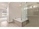 Modern bathroom with glass shower, soaking tub, and marble vanity at 4803 N Woodmere Fairway -- # 2006, Scottsdale, AZ 85251
