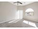Bright bedroom with an arched window and ceiling fan at 8753 E Greenview Dr, Gold Canyon, AZ 85118