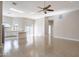 Open living room with tile floors and a ceiling fan, open to kitchen at 8753 E Greenview Dr, Gold Canyon, AZ 85118