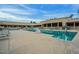 Community pool with lounge chairs and surrounding buildings at 18774 N 95Th Ave, Peoria, AZ 85382