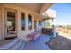 Covered patio with outdoor table and a view of the desert landscape at 30218 N 162Nd Way, Scottsdale, AZ 85262