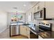 Modern kitchen features stainless steel appliances and updated cabinetry at 6617 E Northridge St, Mesa, AZ 85215