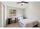 Cozy bedroom with a double bed, desk, and ceiling fan at 6617 E Northridge St, Mesa, AZ 85215