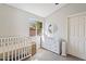 Bedroom featuring a crib, dresser, and window seat at 6617 E Northridge St, Mesa, AZ 85215