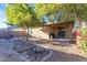 Landscaped backyard with patio, fire pit, and seating at 44395 W Bailey Dr, Maricopa, AZ 85138