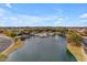 Aerial view of community lake with pool and fountain features at 44395 W Bailey Dr, Maricopa, AZ 85138
