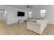 Bright living room featuring a large sectional sofa and flat-screen TV at 44395 W Bailey Dr, Maricopa, AZ 85138