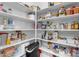 Well-organized pantry with ample shelving for storage at 44395 W Bailey Dr, Maricopa, AZ 85138