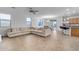 Spacious living room with an open floor plan and L-shaped sectional sofa at 44395 W Bailey Dr, Maricopa, AZ 85138