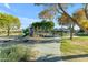 Community playground with play structures and shaded seating at 44395 W Bailey Dr, Maricopa, AZ 85138