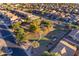 Aerial view of a neighborhood park with playground and trees at 44395 W Bailey Dr, Maricopa, AZ 85138
