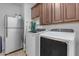 Laundry room with washer, dryer, and cabinets at 44395 W Bailey Dr, Maricopa, AZ 85138