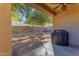 Covered patio with grill and view of the backyard at 44395 W Bailey Dr, Maricopa, AZ 85138
