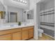 Clean bathroom with double sinks and a shower/tub combo at 44395 W Bailey Dr, Maricopa, AZ 85138