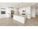 Bright kitchen with white cabinets, granite countertops, and an island at 17305 W Sanna St, Waddell, AZ 85355