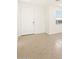 Light-filled living room with tile floors and a door at 17311 W Sanna St, Waddell, AZ 85355