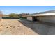 Side view of the house showing the back patio and yard at 380 E Fletcher Ln, Wickenburg, AZ 85390