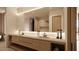 Modern bathroom with double vanity and large mirror at 10948 E Rising Sun Dr, Scottsdale, AZ 85262