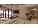 Living room with fireplace, large TV and wine storage at 10948 E Rising Sun Dr, Scottsdale, AZ 85262