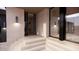 Modern entryway with glass doors and sleek light fixtures at 10948 E Rising Sun Dr, Scottsdale, AZ 85262