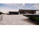 Modern home exterior with two-car garage and expansive driveway at 10948 E Rising Sun Dr, Scottsdale, AZ 85262