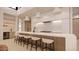 Modern kitchen with island, white cabinets, and wood accents at 10948 E Rising Sun Dr, Scottsdale, AZ 85262