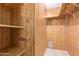 Shelved closet with wood paneling and carpeted floor at 7654 E Calypso Ave, Mesa, AZ 85208