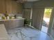 Modern kitchen with wood cabinets and marble floors at 2474 E Westchester Dr, Chandler, AZ 85249